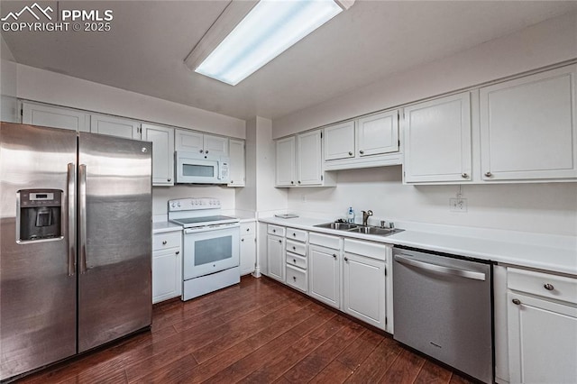 kitchen with white cabinetry, stainless steel appliances, sink, and dark wood-type flooring