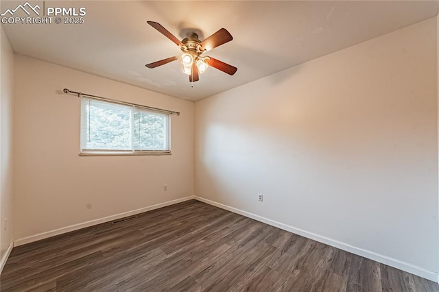 spare room featuring ceiling fan and dark hardwood / wood-style floors