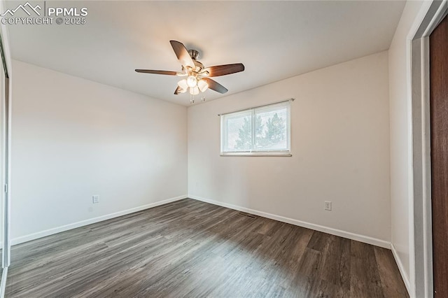 spare room featuring dark hardwood / wood-style floors and ceiling fan