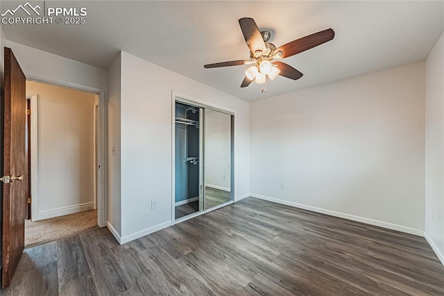 unfurnished bedroom featuring dark hardwood / wood-style flooring, a closet, and ceiling fan