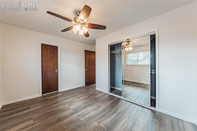 unfurnished bedroom featuring ceiling fan, dark hardwood / wood-style floors, and a closet