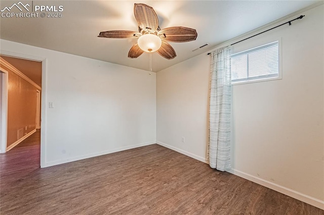 spare room featuring ceiling fan and dark hardwood / wood-style flooring