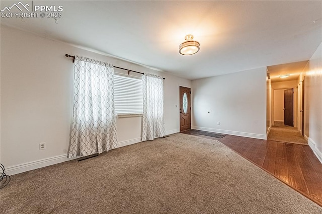 unfurnished room featuring carpet