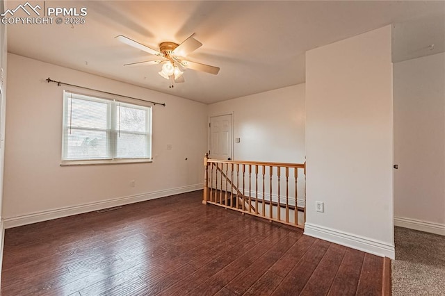 unfurnished room with dark wood-type flooring and ceiling fan