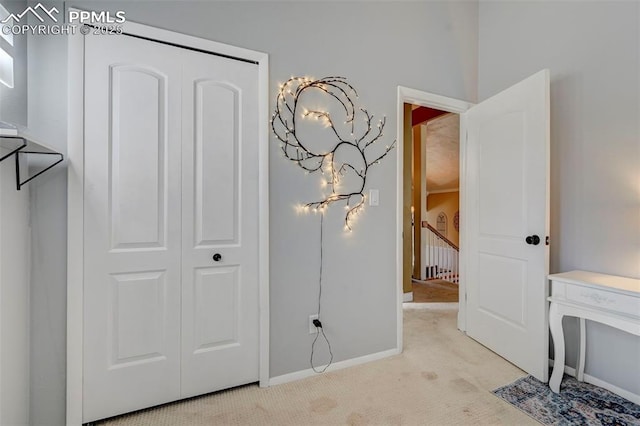 bedroom featuring light colored carpet and a closet