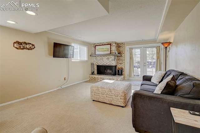 carpeted living room with french doors and a fireplace