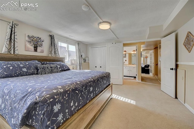 carpeted bedroom featuring a closet and a textured ceiling