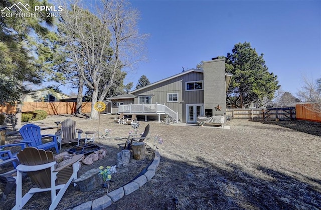 rear view of house featuring a wooden deck