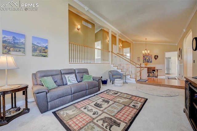 living room with ornamental molding, a chandelier, high vaulted ceiling, and carpet