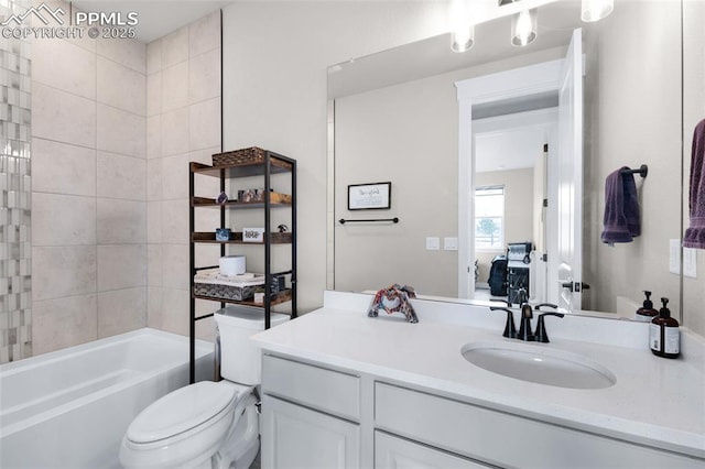 full bathroom featuring tiled shower / bath, vanity, and toilet