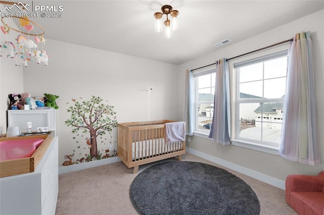 carpeted bedroom with a nursery area