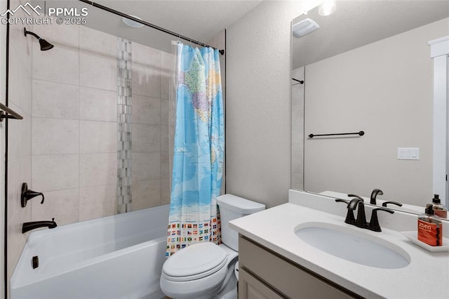 full bathroom featuring shower / tub combo with curtain, vanity, a textured ceiling, and toilet