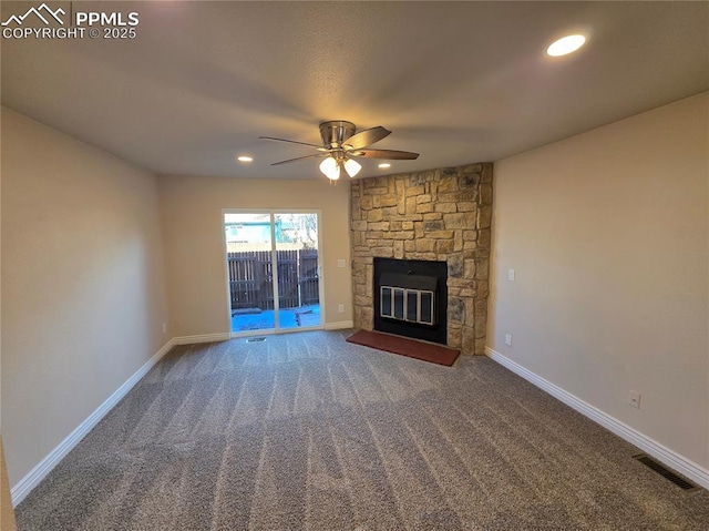 unfurnished living room featuring ceiling fan, a fireplace, and carpet floors