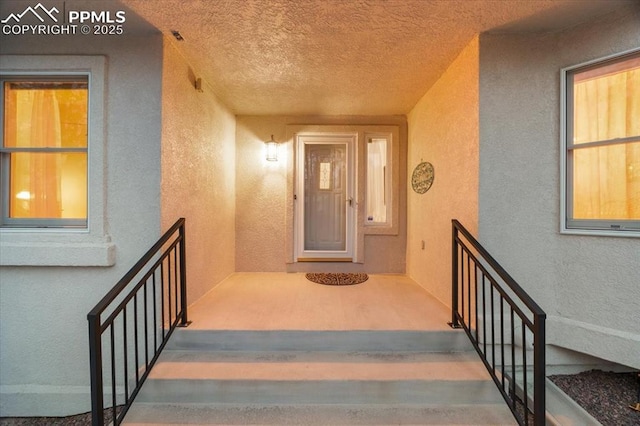 view of exterior entry featuring stucco siding