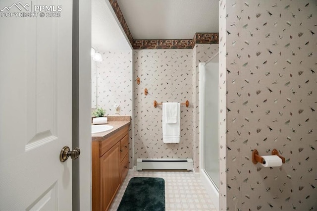 bathroom with a shower stall, wallpapered walls, a baseboard heating unit, tile patterned floors, and vanity