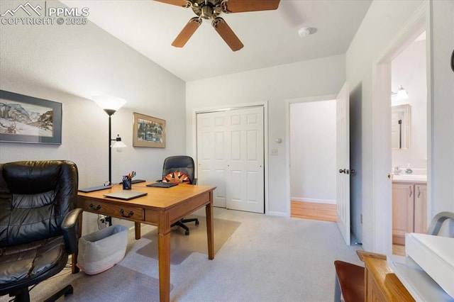 office area with light colored carpet, baseboards, a ceiling fan, and a sink