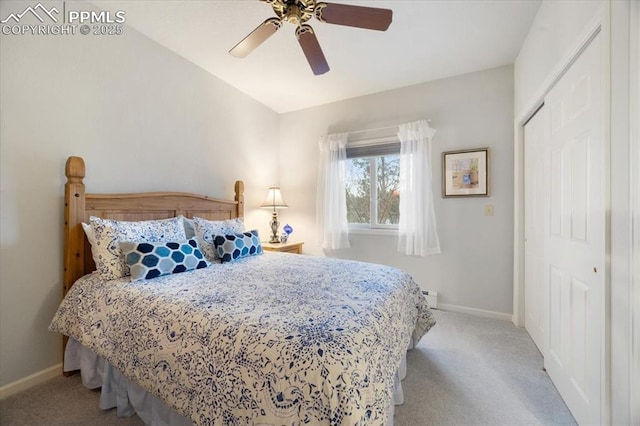 carpeted bedroom featuring a baseboard heating unit, a ceiling fan, baseboards, and a closet