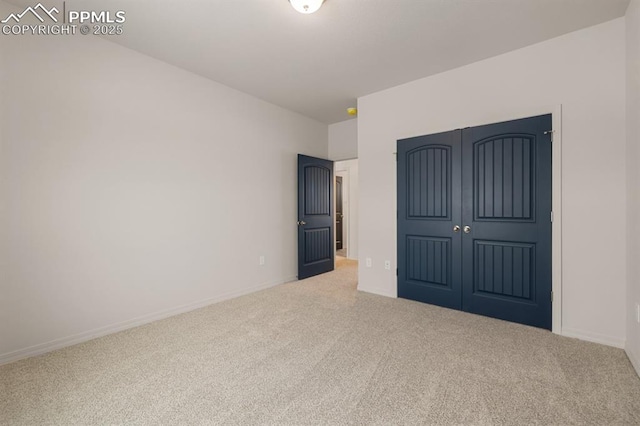 unfurnished bedroom featuring carpet floors and a closet