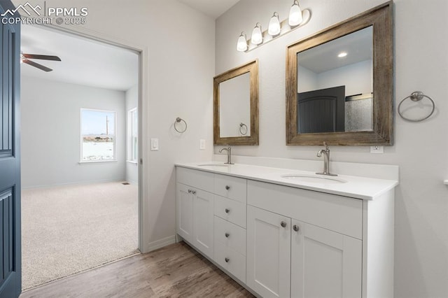 bathroom featuring vanity, hardwood / wood-style floors, and ceiling fan