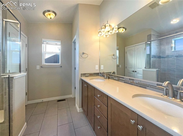 bathroom featuring vanity, tile patterned flooring, and a shower with shower door