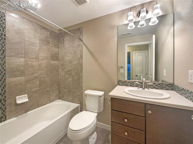 full bathroom featuring vanity, toilet, tiled shower / bath combo, and backsplash