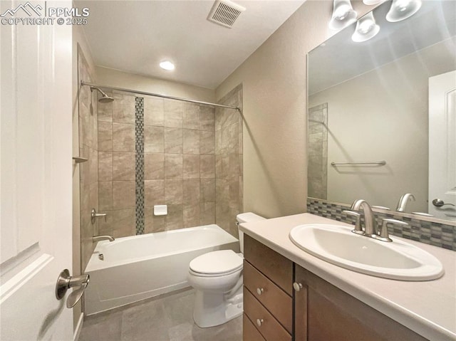 full bathroom featuring tiled shower / bath, vanity, toilet, and decorative backsplash