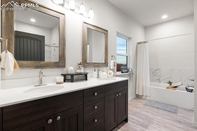 bathroom with vanity, wood-type flooring, and shower / bath combination with curtain