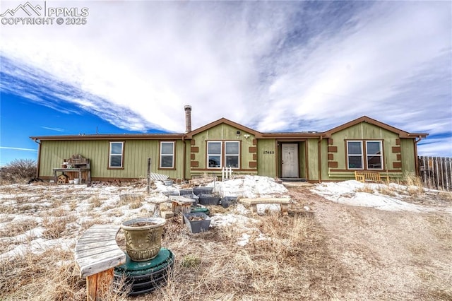 view of front of home featuring fence