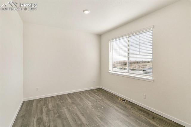 spare room with wood-type flooring