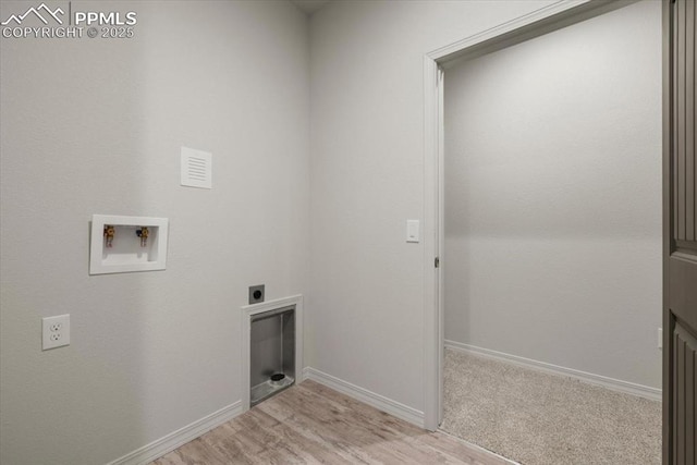 clothes washing area featuring washer hookup, hookup for an electric dryer, and light wood-type flooring