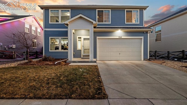 view of front of property featuring a garage and a yard