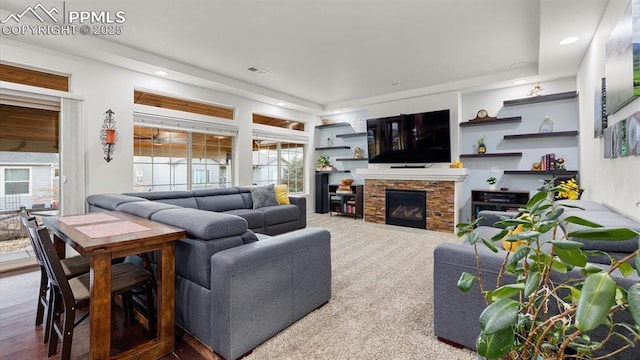 living room with a fireplace and carpet