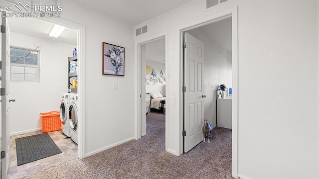 corridor with washer and clothes dryer and carpet