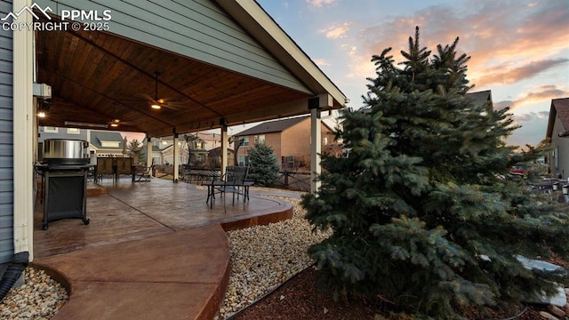 view of patio terrace at dusk