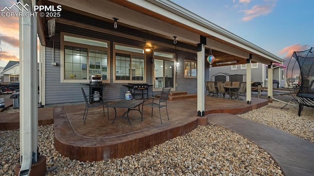 view of patio terrace at dusk