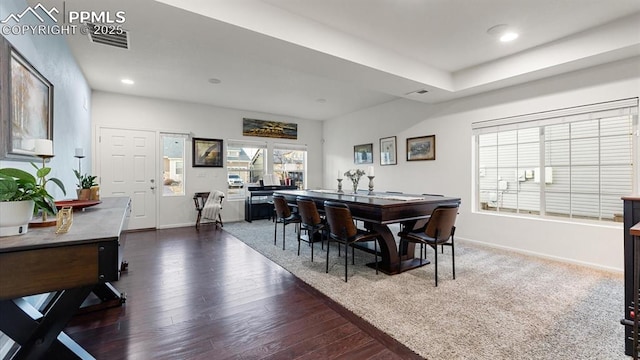 dining space with dark hardwood / wood-style floors