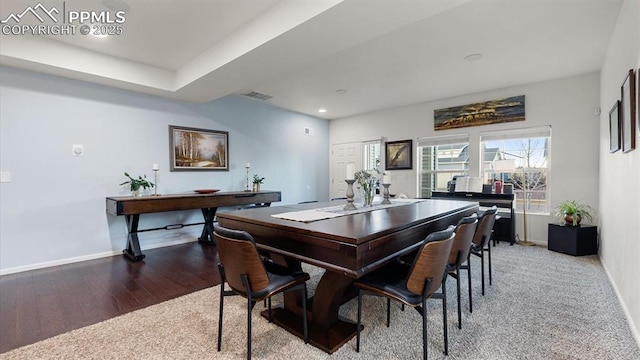 dining space with hardwood / wood-style flooring