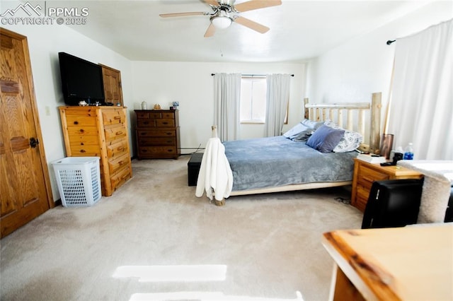 carpeted bedroom featuring baseboard heating and ceiling fan