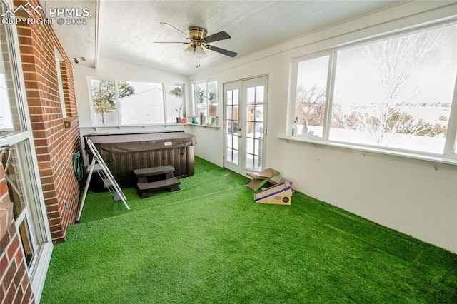 unfurnished sunroom featuring french doors and ceiling fan