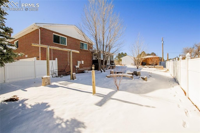 view of yard layered in snow