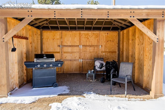 view of patio with an outdoor structure and a grill