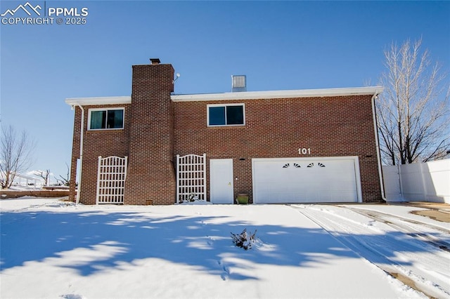 101 Welton Ave, Walsenburg, CO 81089 - view of front of house featuring a garage, brick siding, and a chimney