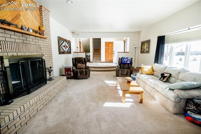 living room with carpet floors and a fireplace