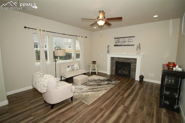 living room with ceiling fan, a fireplace, and dark hardwood / wood-style floors