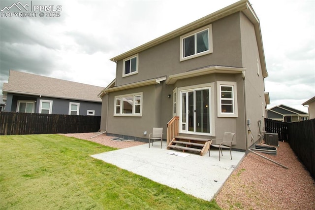 back of house with a yard, a patio area, and central AC