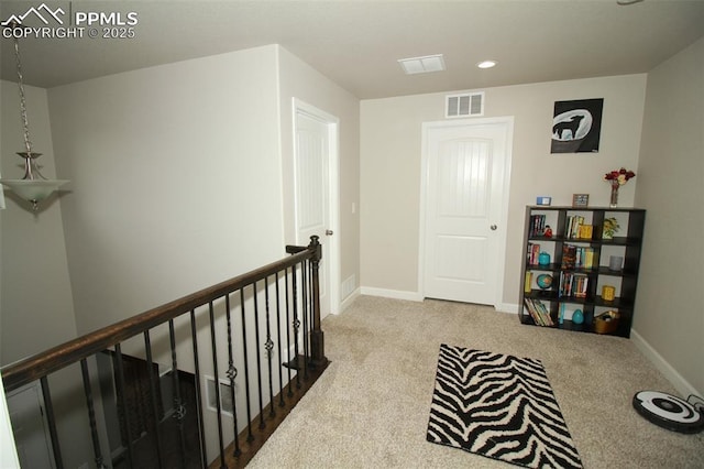 hallway with light colored carpet