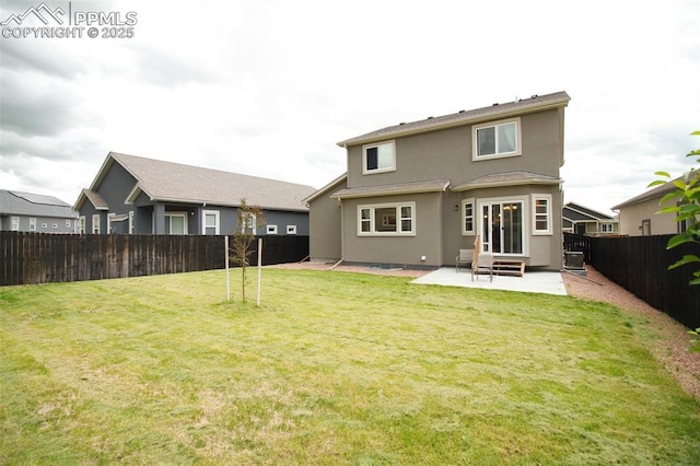 rear view of house with a yard and a patio area