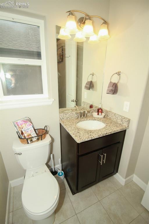 bathroom with vanity, tile patterned floors, and toilet