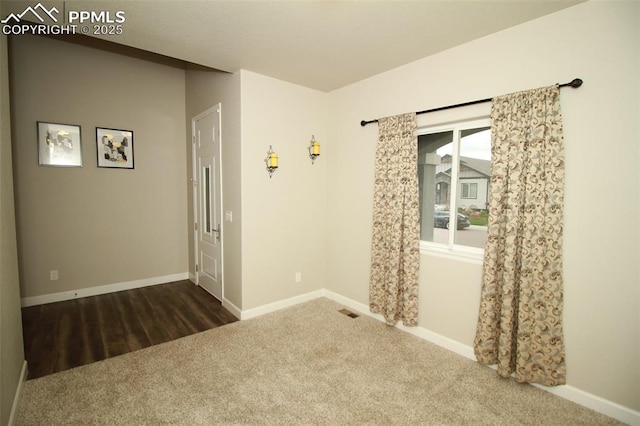 empty room featuring dark colored carpet