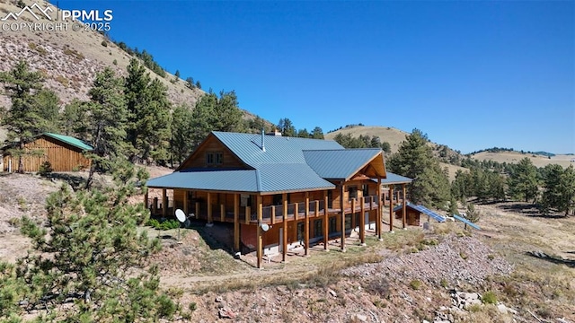 rear view of house featuring a mountain view